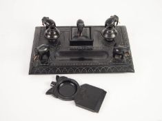 EARLY TWENTIETH CENTURY CARVED EBONY INK STANDISH, with figures of elephants to the corners and