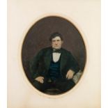VICTORIAN OVAL TINTED PHOTOGRAPH OF A SEATED GENTLEMAN, in original card mount and glazed gilt