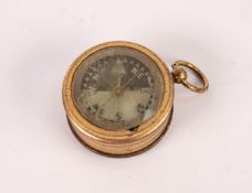 EARLY TWENTIETH CENTURY GILT BRASS COMBINED ANEROID BAROMETER AND COMPASS, in drum shaped case
