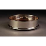 MILLENNIUM HALLMARKED SILVER BOTTLE COASTER, with turned mahogany base, 5? (12.7cm) diameter, boxed