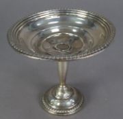 EMPIRE, WEIGHTED STERLING SILVER PEDESTAL DISH, with gadrooned borders, 5? (12.7cm) high, 5 ¾? (14.