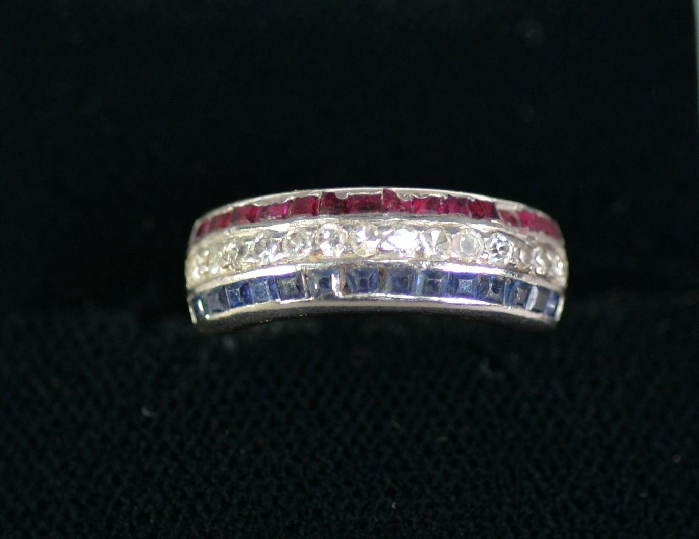 WHITE GOLD COLOURED METAL HALF ETERNITY RING, with a row of fourteen small diamonds flanked by two