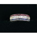 WHITE GOLD COLOURED METAL HALF ETERNITY RING, with a row of fourteen small diamonds flanked by two
