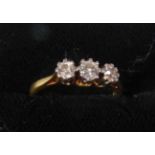 18ct GOLD RING set with a row of three round brilliant cut diamonds, approximately .35ct in total,