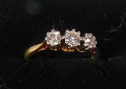 18ct GOLD RING set with a row of three round brilliant cut diamonds, approximately .35ct in total,