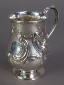 VICTORIAN EMBOSSED SILVER CHRISTENING MUG BY HENRY WILLIAM CURRY, of footed baluster form with