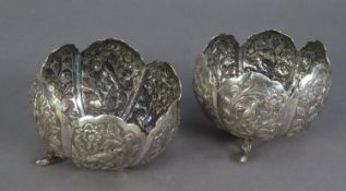 UNMARKED PAIR OF INDIAN EMBOSSED SILVER COLOURED METAL DISHES, of steep sided petal form with