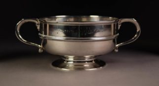 GEORGIAN STYLE SILVER TWO HANDLED PRESENTATION BOWL, of footed form with moulded girdle, scroll