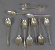 AN INCOMPLETE SET OF NINE EARLY 20TH CENTURY SILVER TEASPOONS AND MATCHING SUGAR TONGS, by