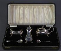 CASED THREE PIECE GEORGIAN STYLE SILVER CONDIMENT SET, of rounded oblong form with pad feet and blue