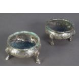 GEORGE III MATCHED PAIR OF EMBOSSED SILVER OPEN SALTS, each of circular form with stepped hoof