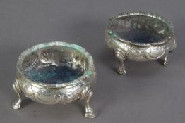 GEORGE III MATCHED PAIR OF EMBOSSED SILVER OPEN SALTS, each of circular form with stepped hoof