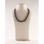 A FACET CUT GARNET BEAD NECKLACE, of approx 71 beads, 18" (46cm) long and a 925 MARK SILVER