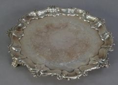 VICTORIAN CHASED SILVER SMALL SALVER, with foliate scroll chased centre, shell capped moulded border