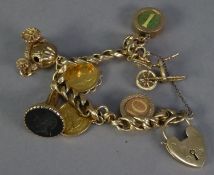 9ct GOLD CURB PATTERN CHARM BRACELET WITH 9ct GOLD PADLOCK CLASP AND 7 GOLD CHARMS, namely two 9ct