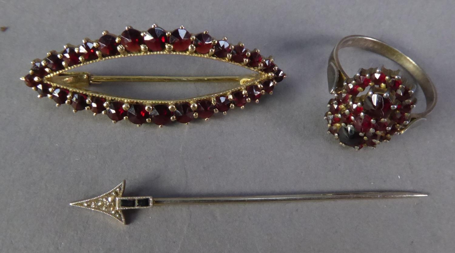 SILVER GILT LOZENGE SHAPED OPENWORK BROOCH, set with approx 28 small garnets, 2 1/2" wide (4cm); A