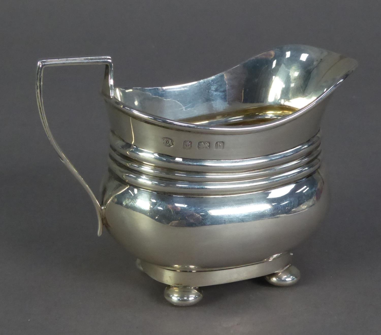 EDWARD VII SILVER CREAM JUG, of rounded oblong form with angular scroll handle, triple moulded