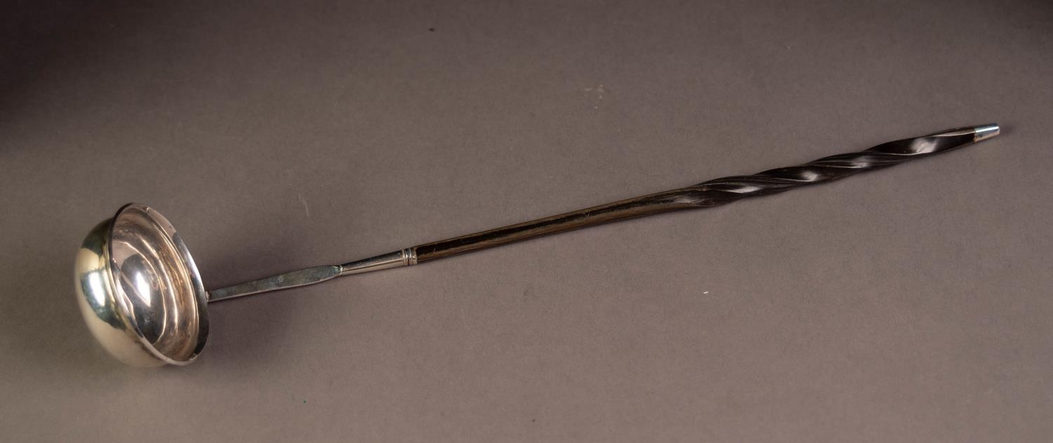 UNMARKED ANTIQUE SILVER COLOURED METAL TODDY LADLE with coin centre and twisted whale bone handle,