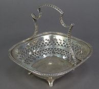 GEORGE V PIERCED SILVER CAKE BASKET BY MARTIN HALL & Co, of rounded oblong form with pierced