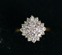 18ct GOLD AND DIAMOND THREE TIER CLUSTER RING, with small centre diamond surround of four larger