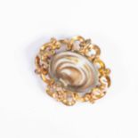 VICTORIAN GOLD COLOURED METAL OVAL BROOCH, the glazed front enclosing a hair scroll and seed pearl