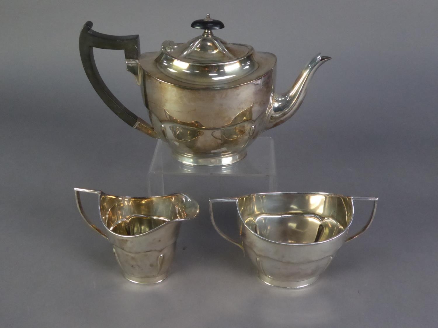 GEORGIAN STYLE ELECTROPLATE TEA SERVICE OF THREE PIECES, of oval form with two handle sucrier, the