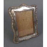 AN EDWARDIAN SILVER FACED PHOTOGRAPH FRAME, wooden backed and easel support, Birmingham 1908