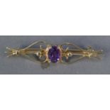 9ct GOLD OPENWORK SCROLL BAR BROOCH, collet set with centre oval amethyst, 2.3gms