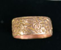 9ct GOLD BROAD WEDDING RING chased with leaves and flowers, Birmingham 1916, 5.5 gms, ring size U/V