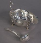 GEORGE VI SILVER SAUCE BOAT, of typical form with flying scroll handle, cyma border and stepped