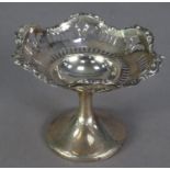 GEORGE V PIERCED AND WEIGHTED SILVER PEDESTAL SMALL SWEET MEAT DISH, slot pierced beneath a scroll