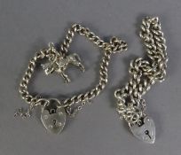 TWO SILVER CURB PATTERN CHAIN BRACELETS, with padlock clasps, one also with a silver charm in the