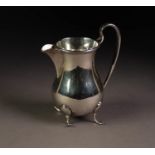 GEORGE V SILVER MILK JUG OF HEAVY GAUGE, of plain pyriform with high scroll handle and scroll
