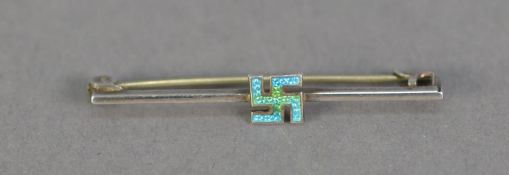 An EARLY 20TH CENTURY 'STERLING' SILVER AND PALE BLUE ENAMELLED SWASTICA BAR BROOCH, by Charles