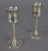 GEORGE V PAIR OF PLANISHED SILVER SMALL GOBLETS BY WALKER & HALL, each with thistle shaped bowl,