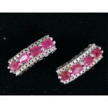 PAIR OF WHITE GOLD (unmarked) RUBY AND DIAMOND EARRINGS for pierced ears, each earring slightly