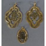 TWO SIMILAR CHINESE 14ct GOLD PIERCED PENDANTS with Chinese characters within a scolloped oval