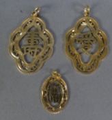 TWO SIMILAR CHINESE 14ct GOLD PIERCED PENDANTS with Chinese characters within a scolloped oval