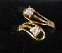 14ct GOLD CROSSOVER RING having double loop pattern top set with two round brilliant cut diamonds,