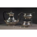 THREE PIECE ELECTROPLATED TEA SET, of part fluted, rounded oblong form with black angular scroll