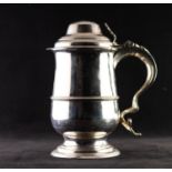 GEORGE II SILVER QUART TANKARD WITH COVER, of footed form with moulded girdle, fancy scroll handle