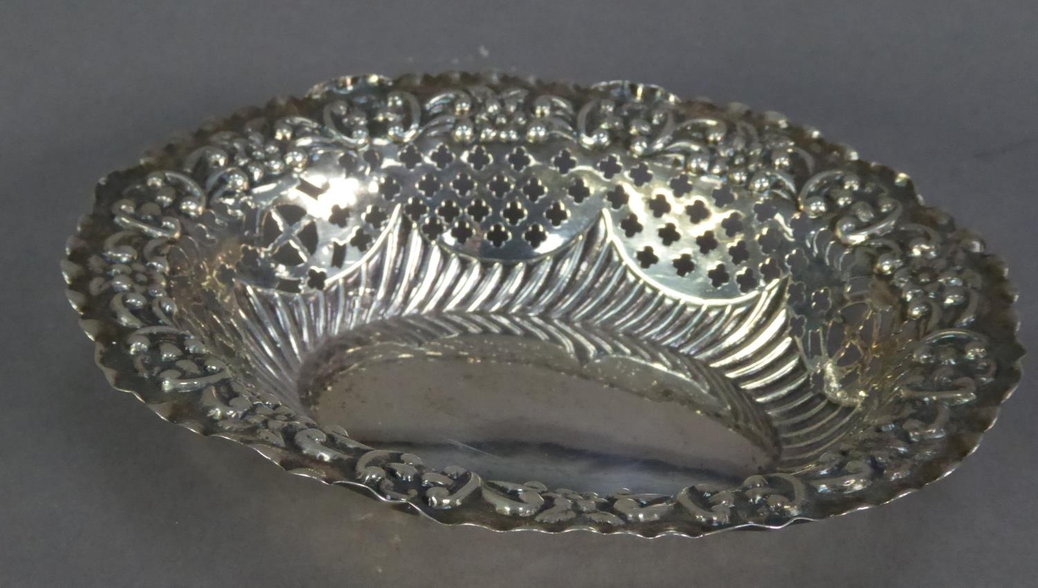 LATE VICTORIAN EMBOSSED AND PIERCED SILVER BON ON DISH, of oval form with lattice pierced panels and