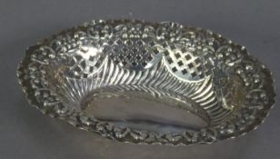 LATE VICTORIAN EMBOSSED AND PIERCED SILVER BON ON DISH, of oval form with lattice pierced panels and