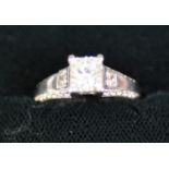 18ct WHITE GOLD RING with a princess cut solitaire diamond in a four claw setting, a princess cut