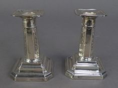 PAIR OF EDWARDIAN SILVER SHORT, WEIGHTED CANDLESTICKS, the tapered octagonal column alternately