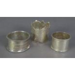 THREE VICTORIAN AND LATER SILVER NAPKIN RINGS, including a fancy, engraved example, date mark