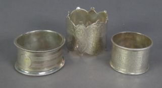 THREE VICTORIAN AND LATER SILVER NAPKIN RINGS, including a fancy, engraved example, date mark