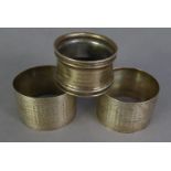 PAIR OF GEORGE V SILVER CIRCULAR NAPKIN RINGS with engine turned decoration, Birmingham 1919 and