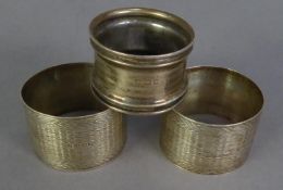 PAIR OF GEORGE V SILVER CIRCULAR NAPKIN RINGS with engine turned decoration, Birmingham 1919 and