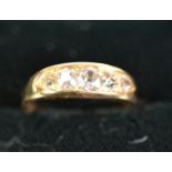 18ct GOLD RING with a lozenge shaped setting of 5 old cut diamonds graduating from the centre,